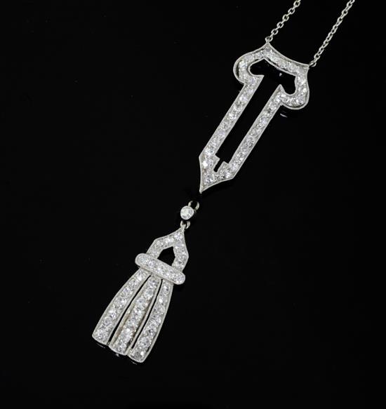 A 19201930s Art Deco 18ct gold, platinum and platinum set open work drop pendant, pendant 55mm.